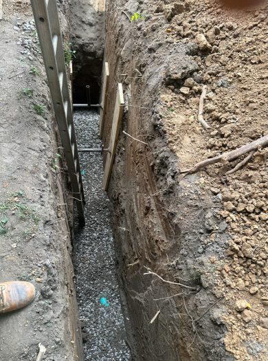 A trench with a hole in it and some dirt